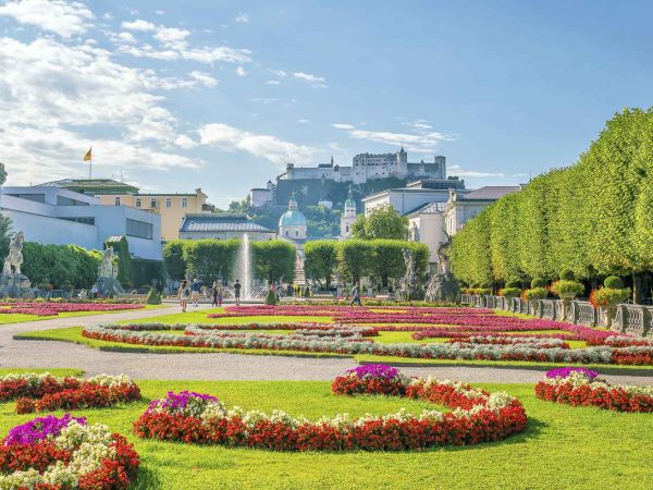 Beautiful view of famous Mirabell Gardens with the old historic Fortress Hohensalzburg in the background, Salzburg in Austria
